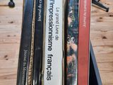 three books that are sitting in a box on a table