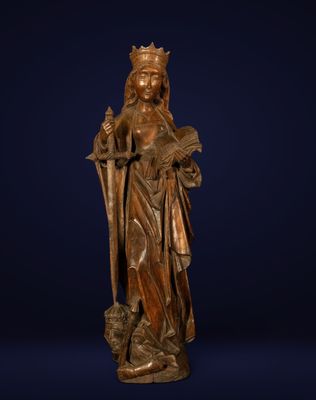 a bronze statue of a woman with a crown on her head