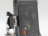 an old camera that is sitting on a white surface