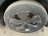 a tire with a flat tire on the side of the road