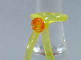 a glass vase with a yellow ribbon around it
