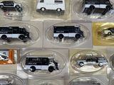many different types of toy cars in the display case