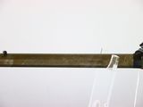 a wooden pole with a glass holder attached to it