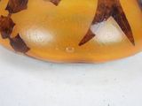 an orange and brown vase with two birds on it