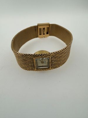 a close up of a wrist watch on a white surface
