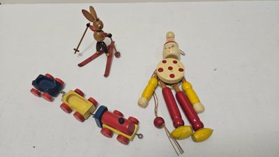 three wooden toys that are on a white surface