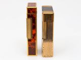 pair of gold and tortoise glass lighters on a white surface