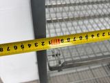 a measuring tape that is on a shelf in a room