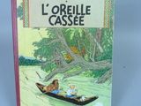 livre pour enfants français, *L'oreille cassée*, avec des illustrations représentant deux personnes dans un bateau