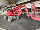 a red lift truck parked inside of a building