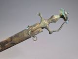 a bronze sword with a bird on the handle