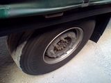 a close up of a flat tire on the side of a truck