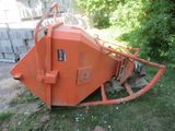 a large orange machine that is sitting in the grass