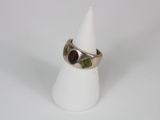 silver ring with garnetts and garnetts on it on a white cone