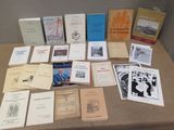 a lot of books on a table that are sitting on the table