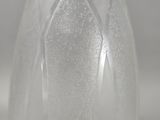 a close up of a clear glass vase with frosting on it