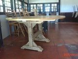 a table and chairs in a room with a red tile floor