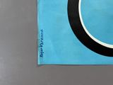 a picture of a black and white circle on a blue piece of paper