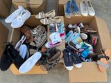 a box full of shoes and other items on the ground