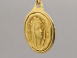a close up of a gold coin with a woman ' s face on it