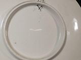 a white plate with a ring on it sitting on a table