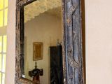 a mirror hanging on the wall in a room