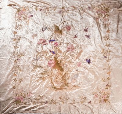 an image of a bed with a white comforter with flowers and birds on it