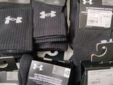 several pairs of under armour socks are on display in a store