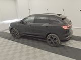 the rear end of a black suv parked in a garage