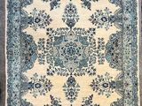 a blue and white rug sitting on top of a wooden floor