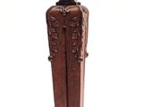 a wooden statue of a man with a hat on top of it
