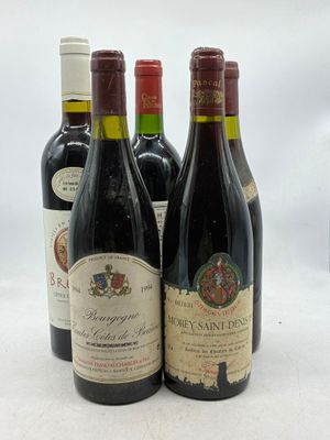 quatre bouteilles de vin sont alignées sur une surface blanche