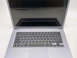 a silver laptop computer sitting on a white table
