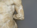 marble statue of a man holding a bowl in his right hand