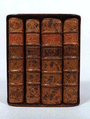 an old book case filled with lots of books sitting on top of a table