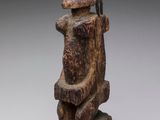 an image of a wooden statue of a man with a hat on