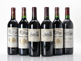 six bottles of wine are lined up in a row on a white surface