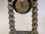 a black and gold clock sitting on top of a table