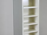 a tall white bookcase with several shelves in it