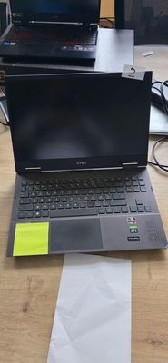 a laptop computer sitting on top of a wooden desk