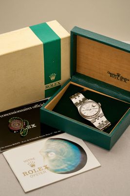 a box with a watch inside of it on a table