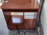 a small wooden table with a glass top and a drawer underneath it