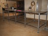 an image of a kitchen with a table in the middle of the room