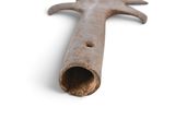 a metal object that looks like a hand holding a pipe