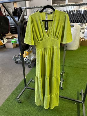 yellow dress hanging on a rack in a clothing store