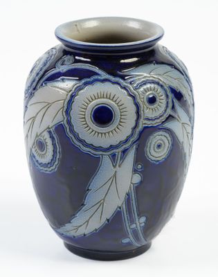 a blue and white vase with a flower design on it