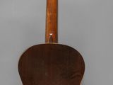 an acoustic guitar hanging on a wall in a room
