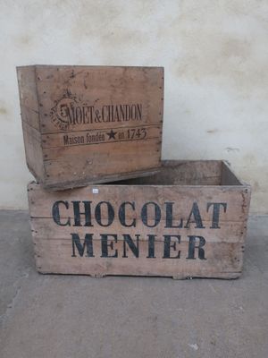 two wooden boxes that have chocolate menter on them