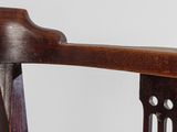 a close up of a wooden chair with holes in the back