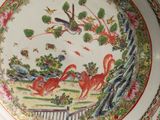 a plate with a painting of birds and flowers on it
